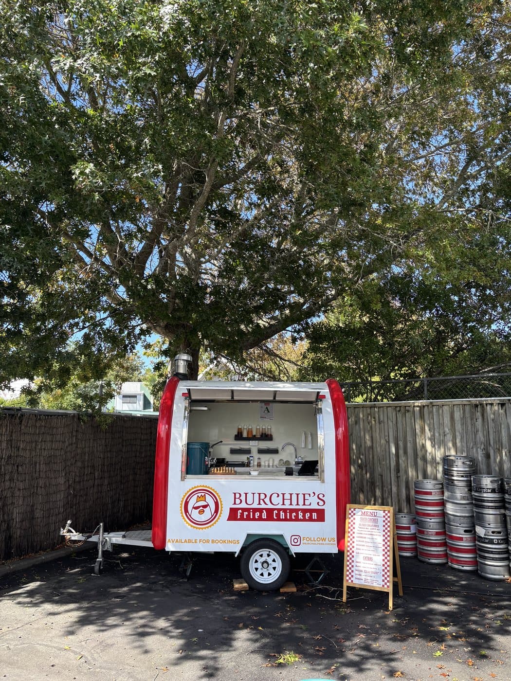 Burchie’s trailer beneath a tree