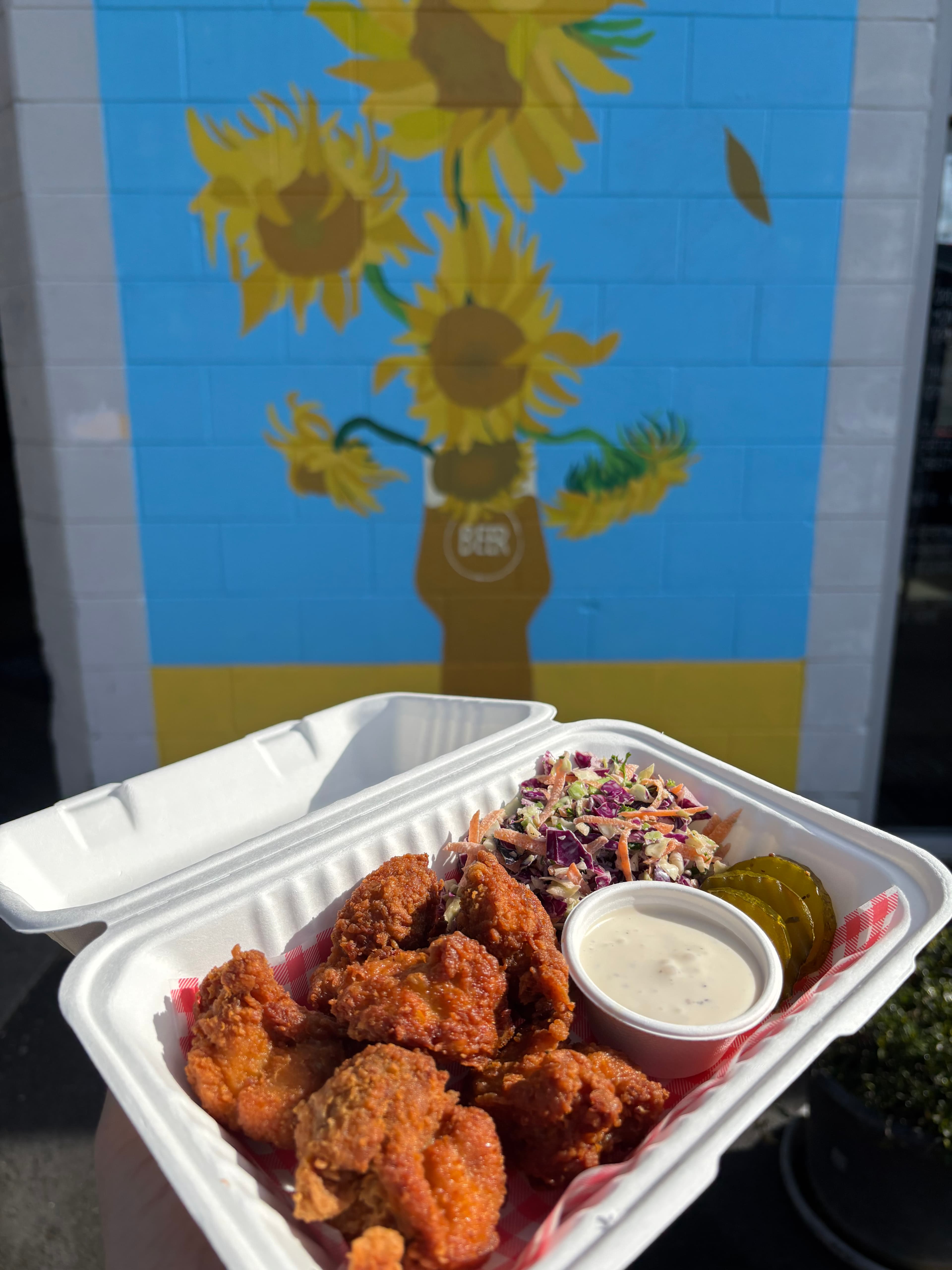 Burchie’s fried chicken meal with slaw, pickles, and sauce